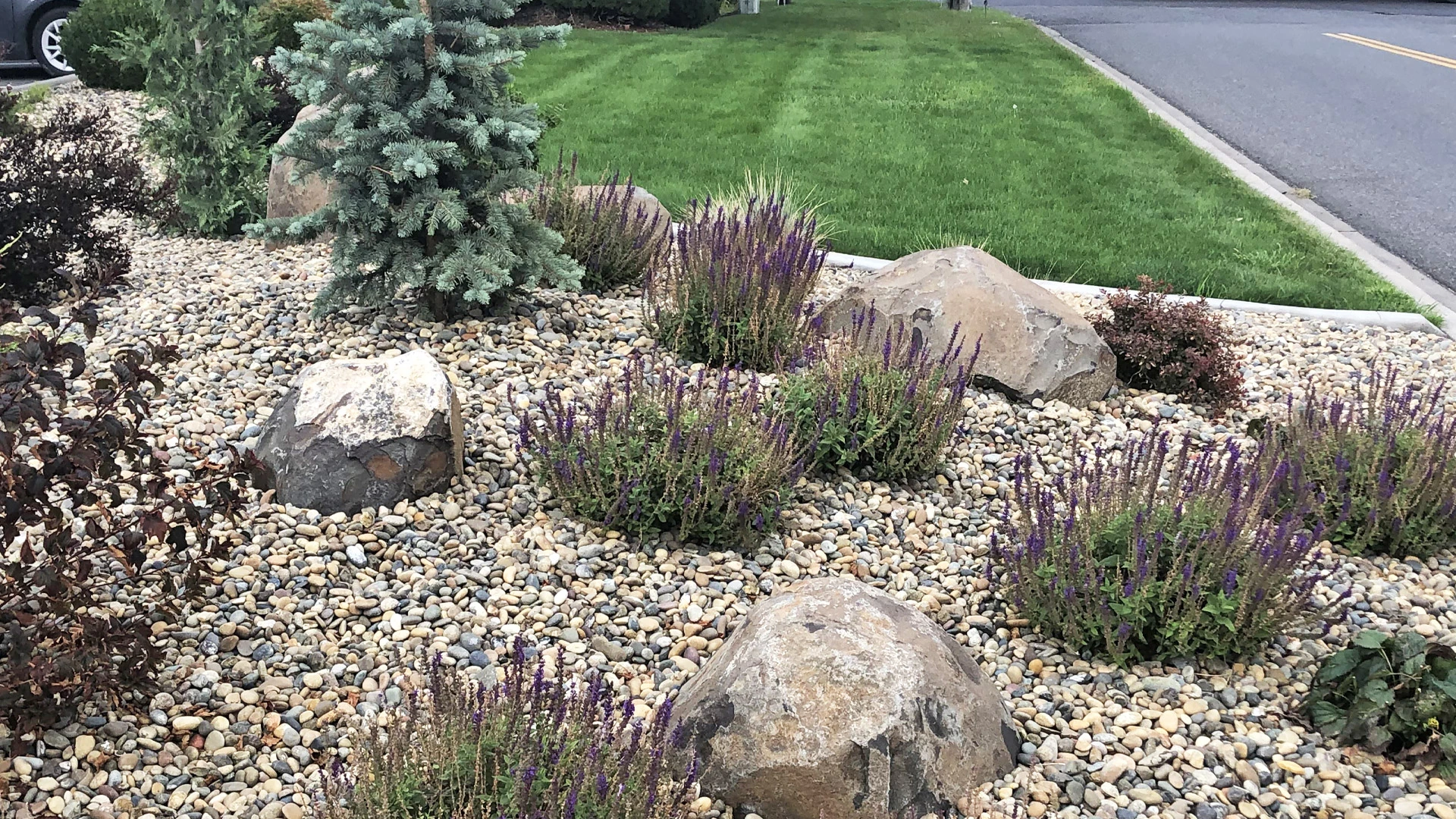 Landscape bed installation with new rock installed at a home in Camas, WA.